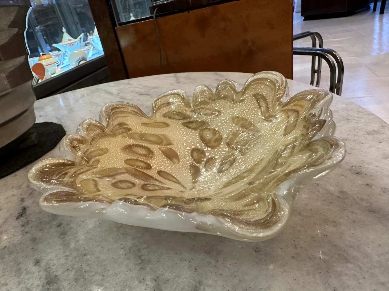 antique Murano glass bowl with golden details on a neutral background