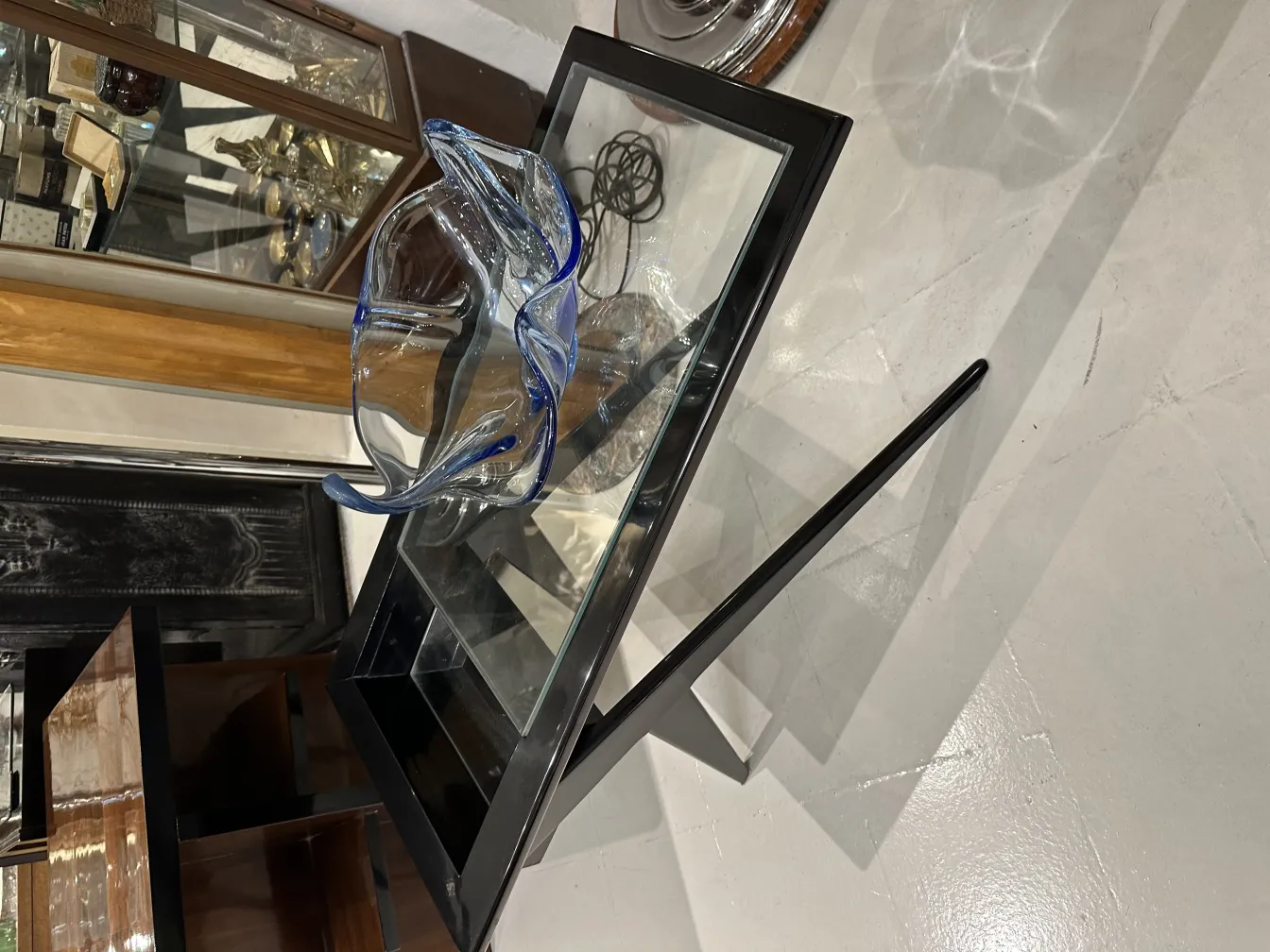 murano glass bowl with blue rim on glass table