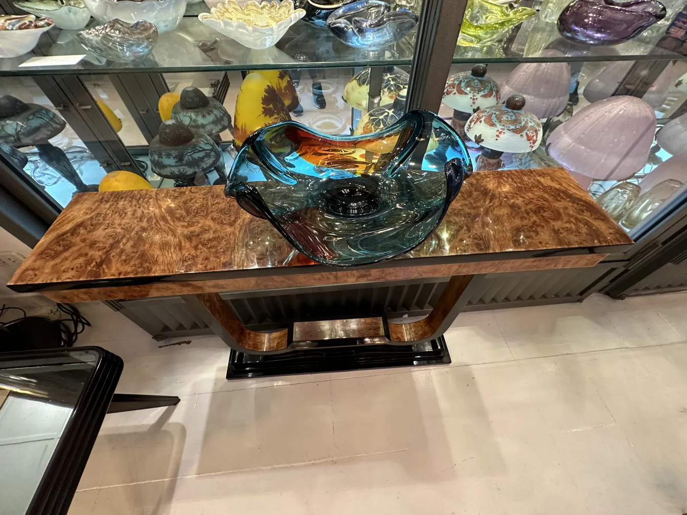 murano glass bowl with blue and amber tones on a wooden table