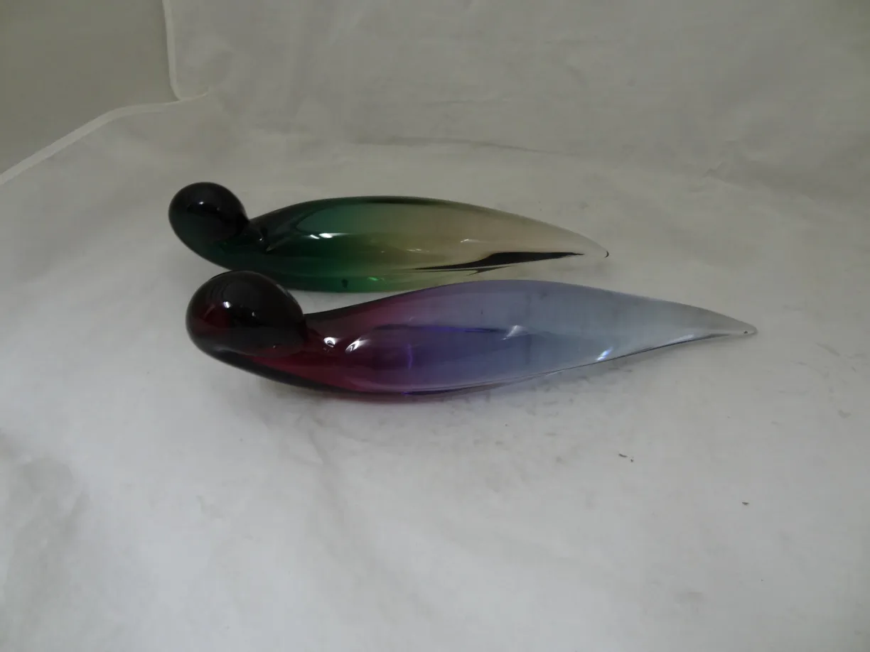 two murano glass figures in green and purple colors