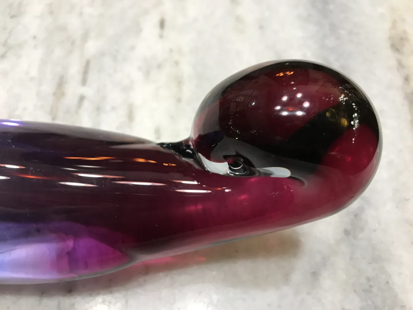 detail of an antique murano glass piece in purple shades