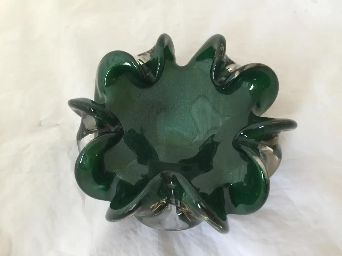 Antique Murano glass sculpture, shiny green with wavy edges.