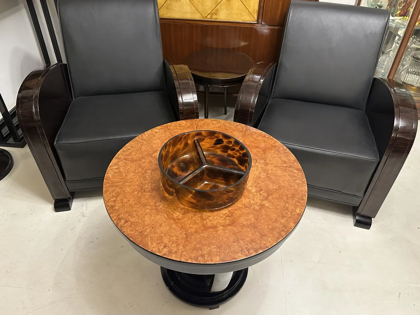 bol décoratif en cristal de murano sur une table ronde avec des chaises noires