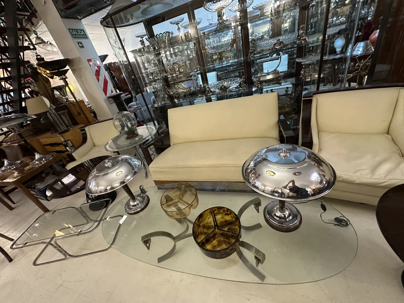 su un tavolo di vetro, antico vetro di murano decorativo, lampade e sedie