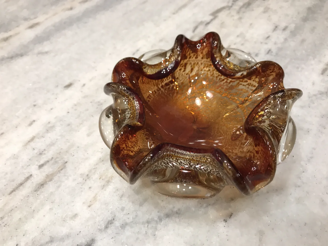 beautiful decorative murano glass piece in amber tones with wavy edges