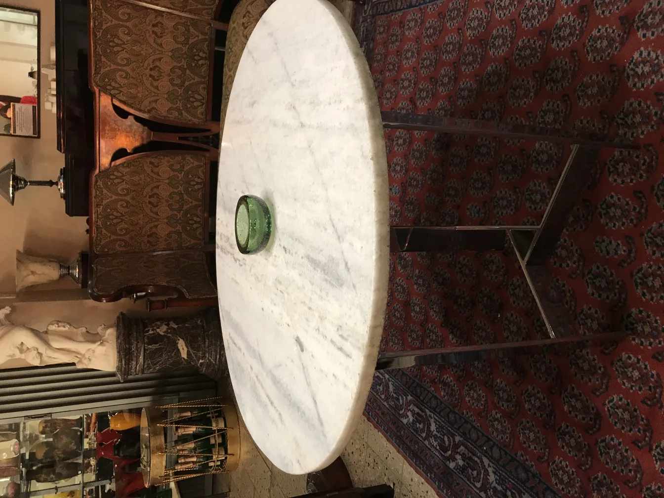 Antique Murano glass on a round table, elegant background.