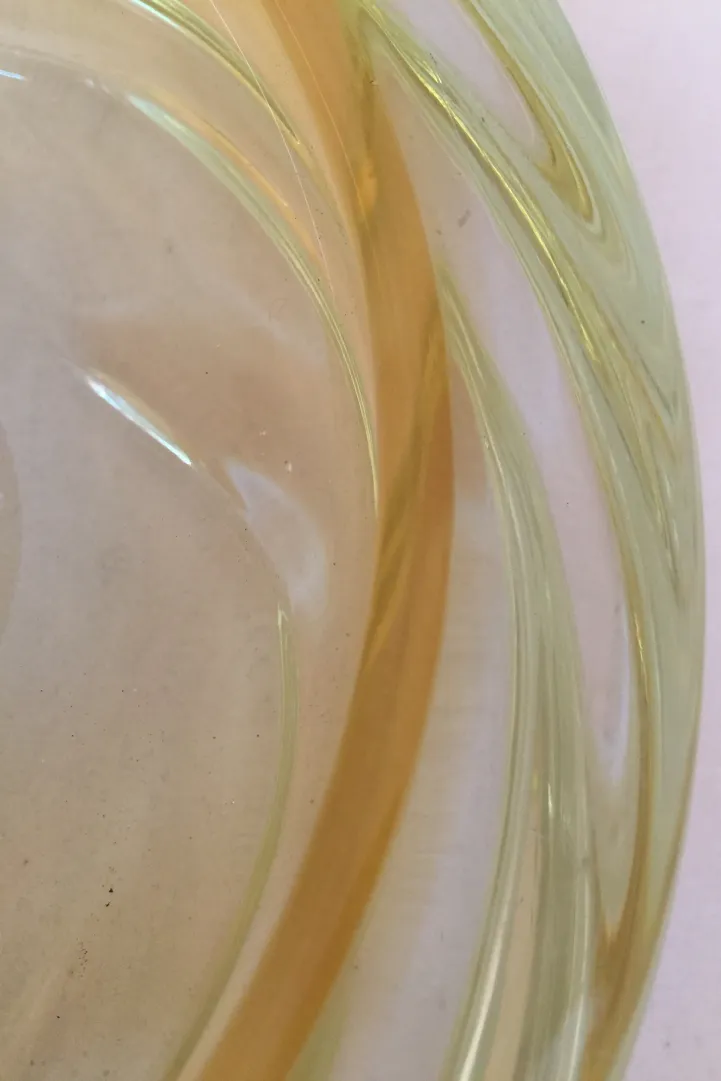 Detailed antique Murano glass in yellow tones, with smooth curves.