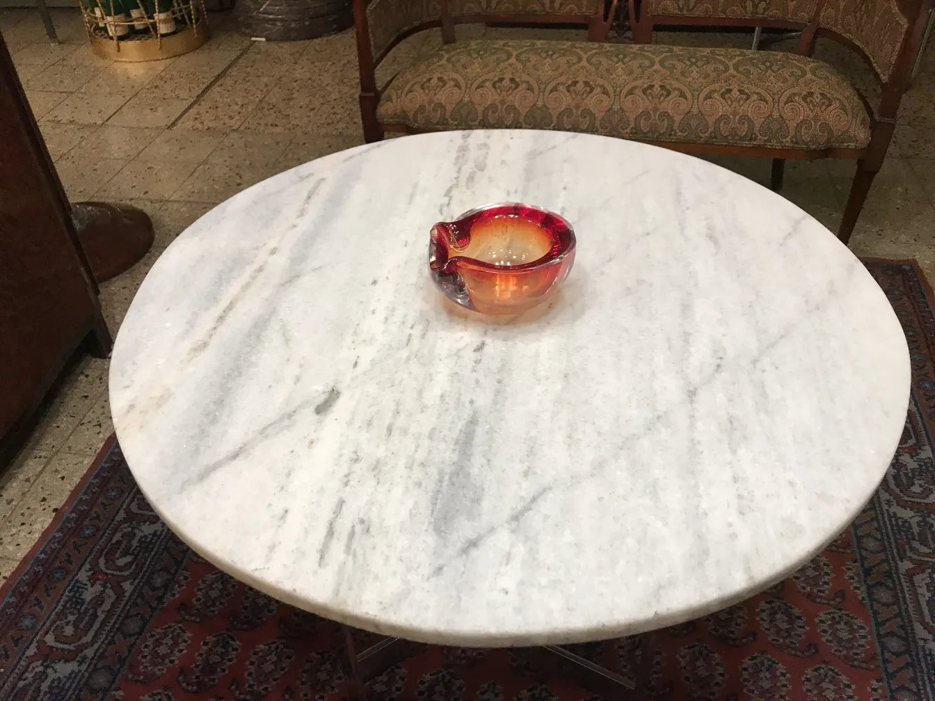murano glass bowl with orange and red tones on a table