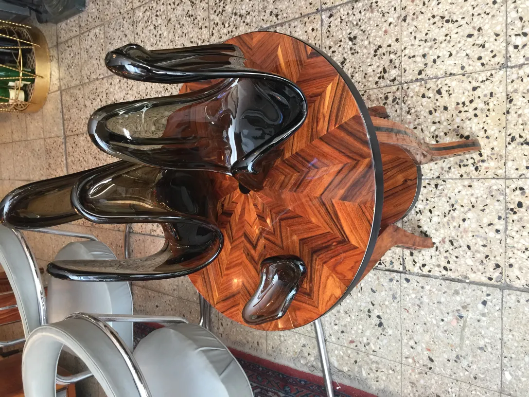 antique murano glass sculpture black with fluid shapes on wooden table