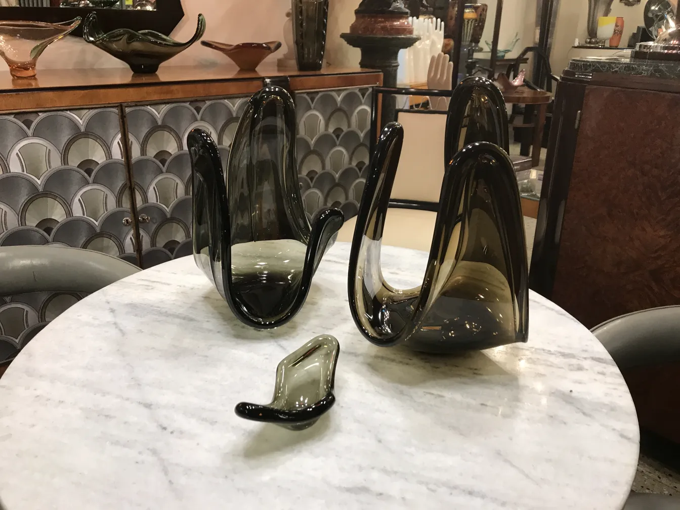 Murano glass sculptures with elegant shapes on a marble table