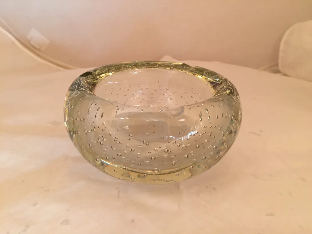 Antique Murano glass vase with air bubbles, simple elegant design. Neutral background.