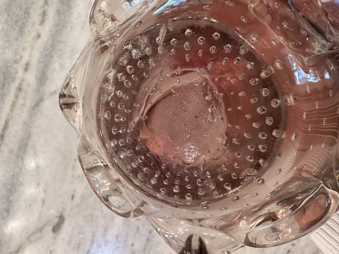 Antique Murano glass with decorative bubbles and elegant design.