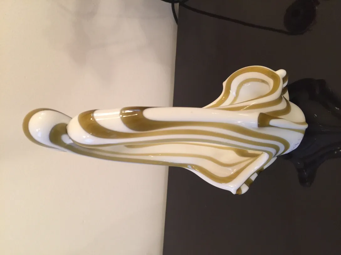 Antique Murano glass with a flowing design in light and dark shades.