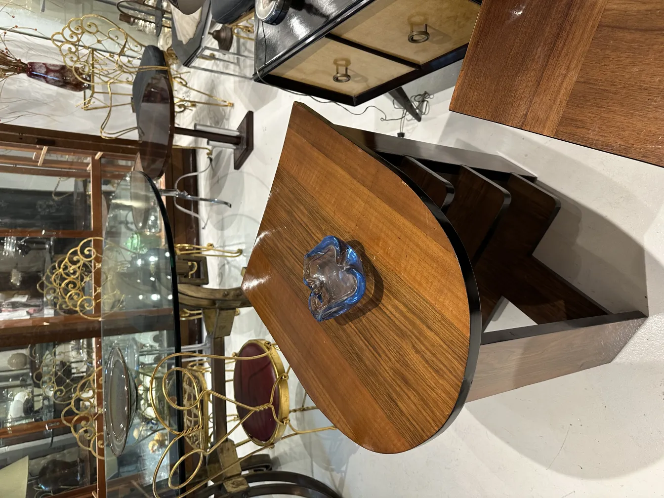 decorative antique murano glass blue on wooden table with background of antique objects