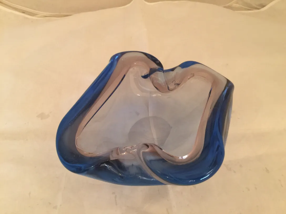 beautiful piece of murano glass in blue with wavy and smooth edges