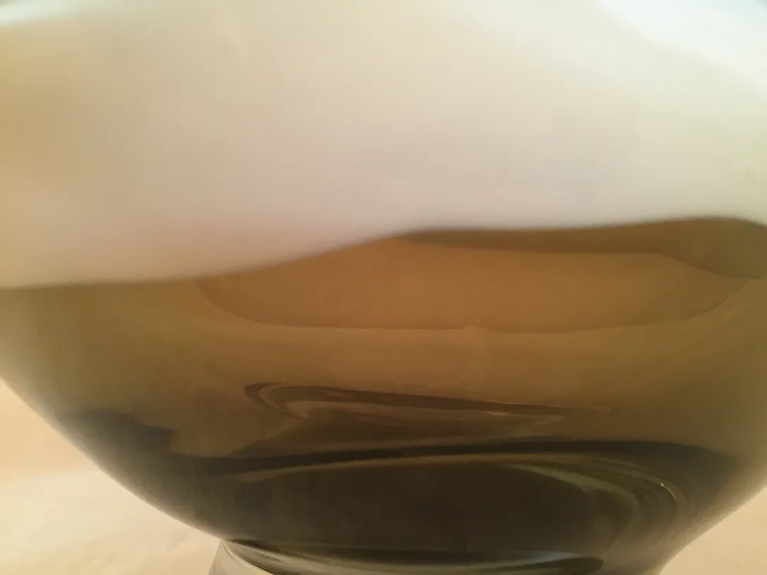 Antique Murano glass featuring an elegant design and organic shapes in a serene setting.