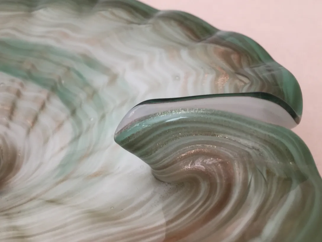 antique piece with green and beige swirling design