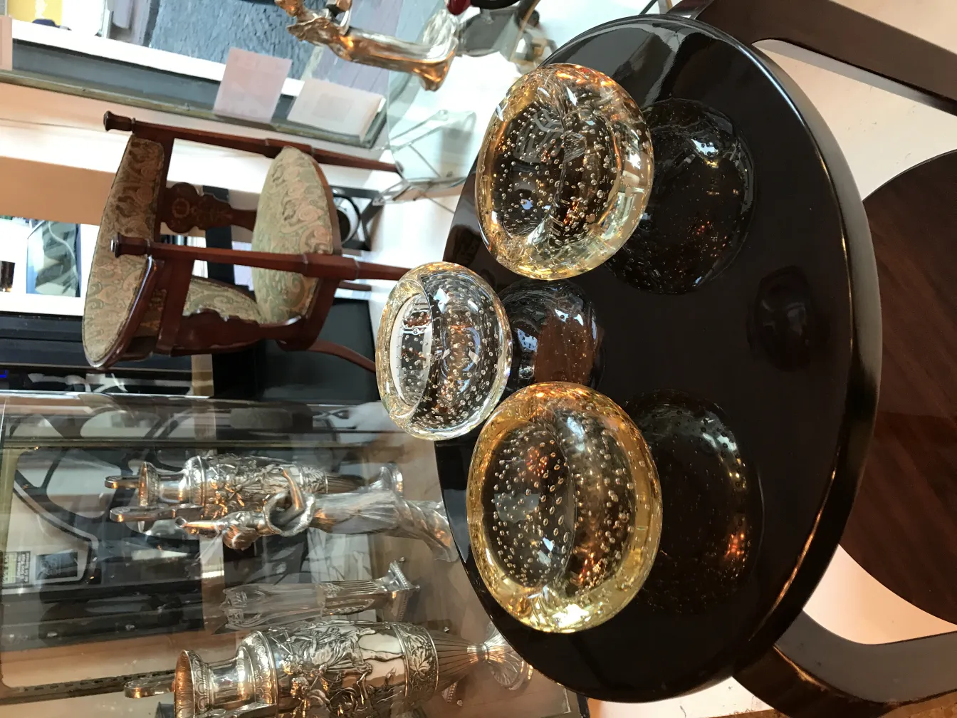 three antique murano glass pieces on black table