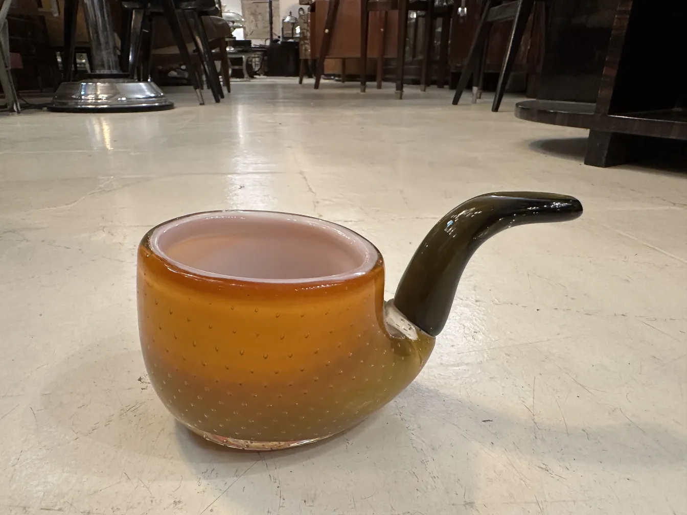 murano glass with a bowl shape, amber color, subtly designed with an elegant base in an antique setting