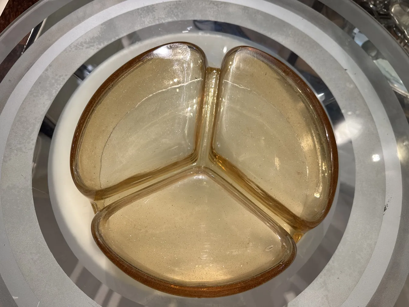 vintage murano glass plate in golden tones, triangular shape, elegant decor on light background