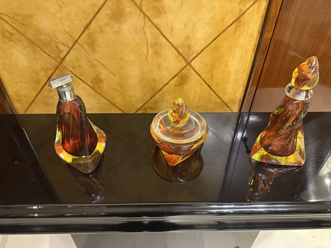 three antique murano glass vases in warm colors