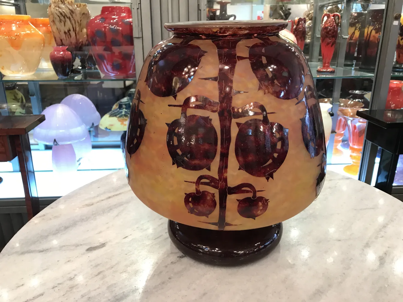 Antique vase with painted decorations in warm tones.