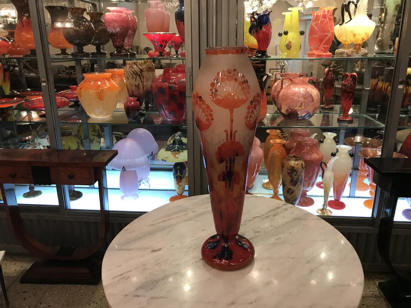 tall glass vase with floral design in antique setting