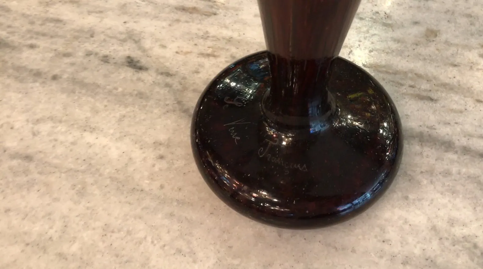 Detailed view of an antique signed glass, with a clear background.