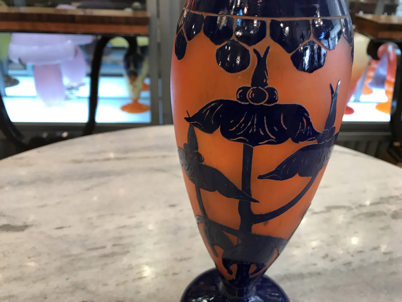 verre signé Le Verre avec motif floral en orange et bleu, faisant partie d'une collection d'antiquités.