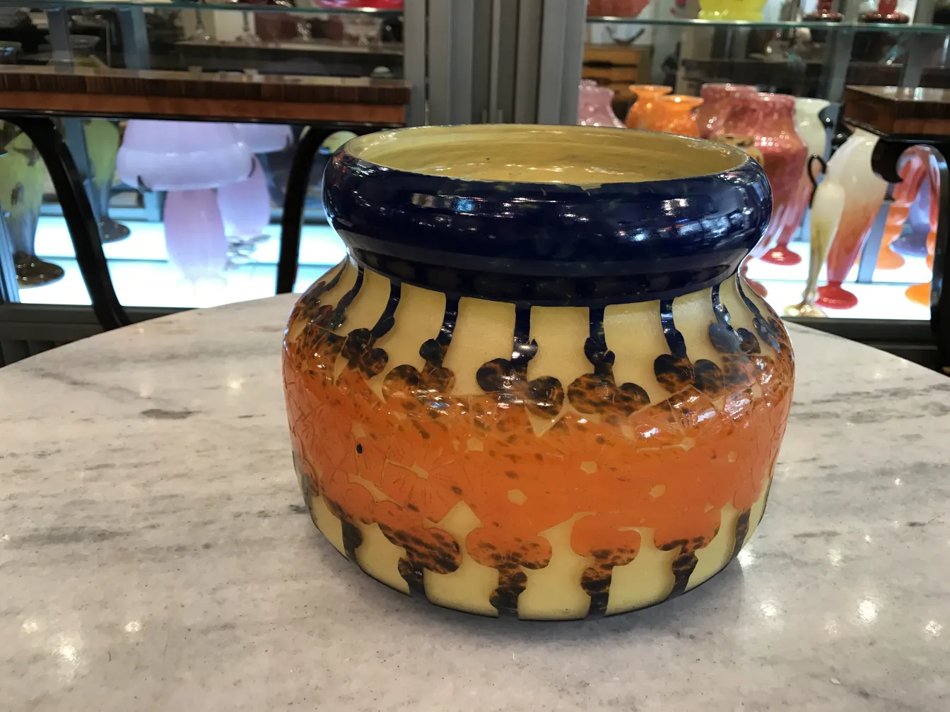 Bright antique vase with colorful design, light background.