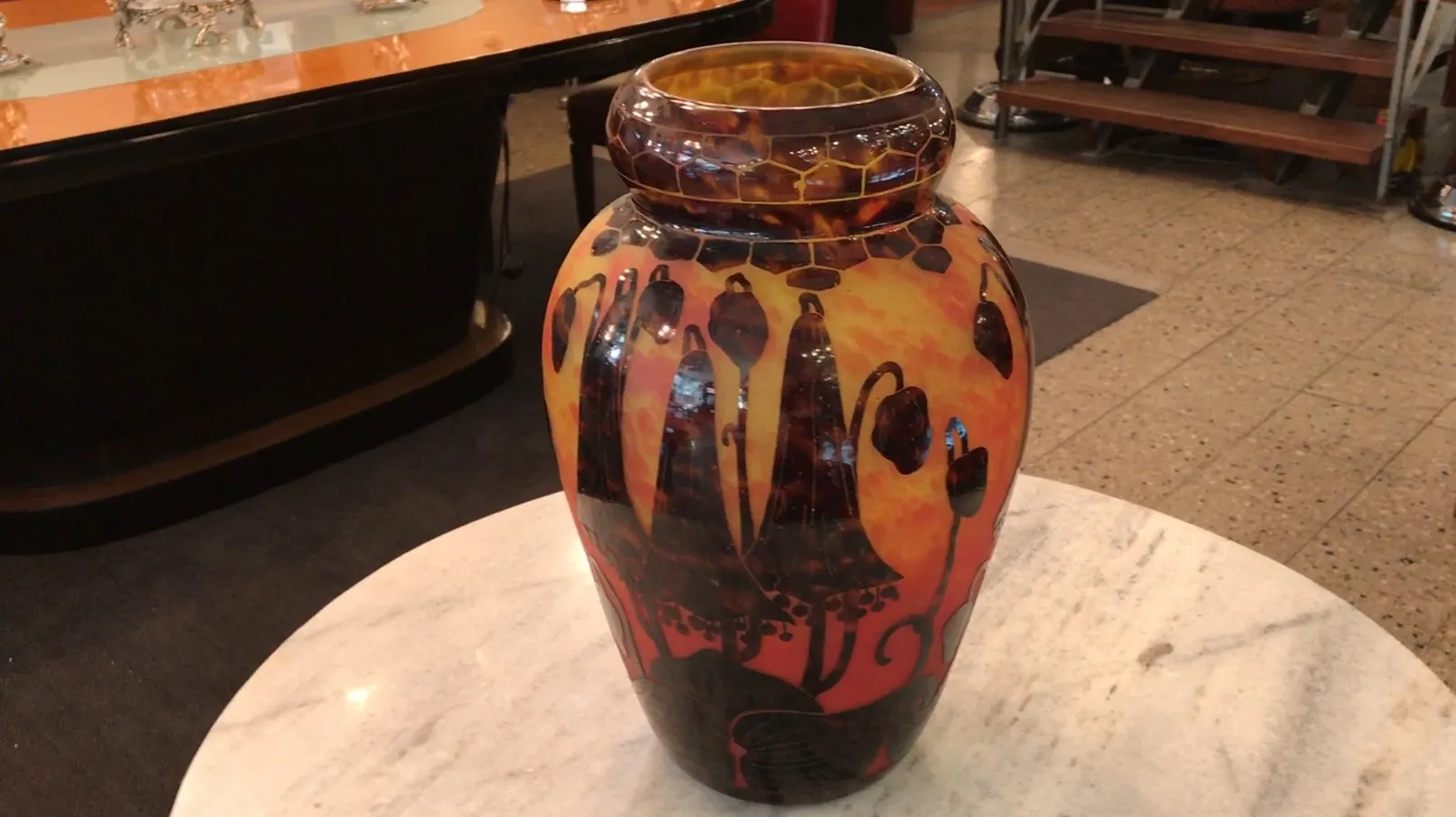 Antique vase featuring floral patterns and warm colors.