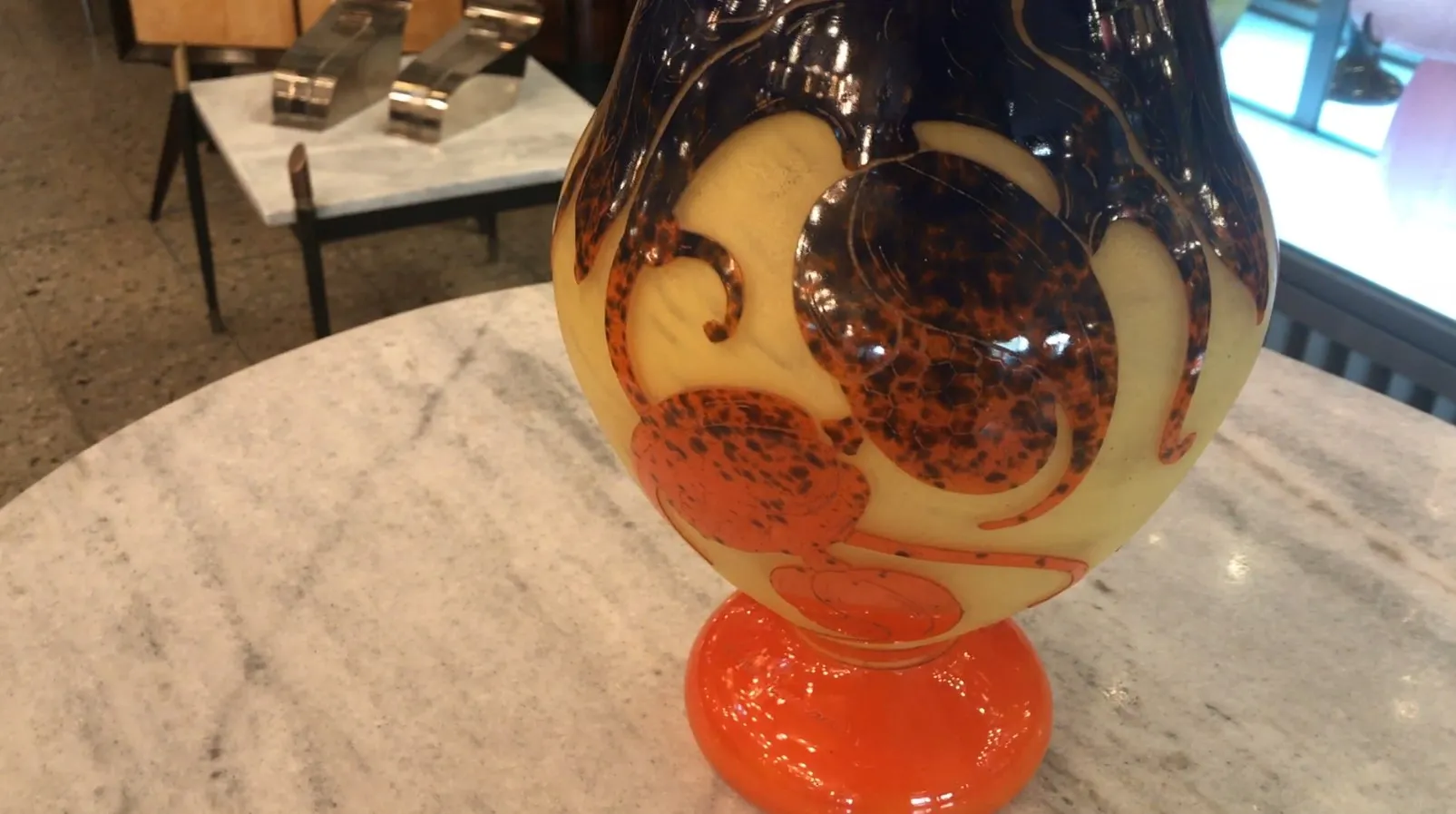 Antique signed glass Le Verre with warm decorative details, marble background, and modern ambiance.