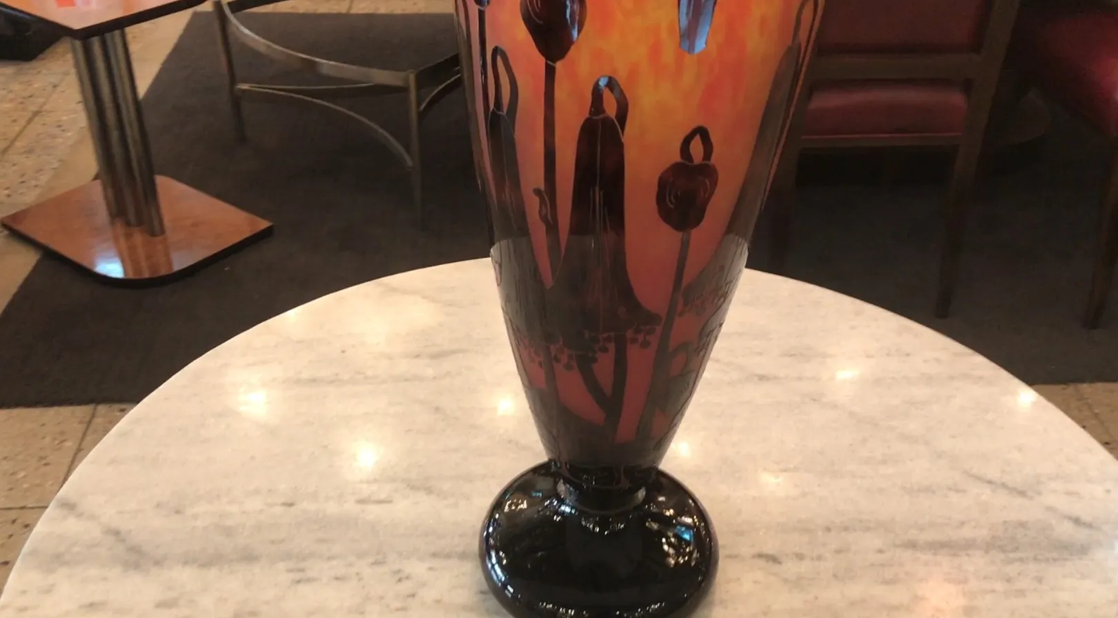 Antike Vase mit floralem Design auf rotem Hintergrund