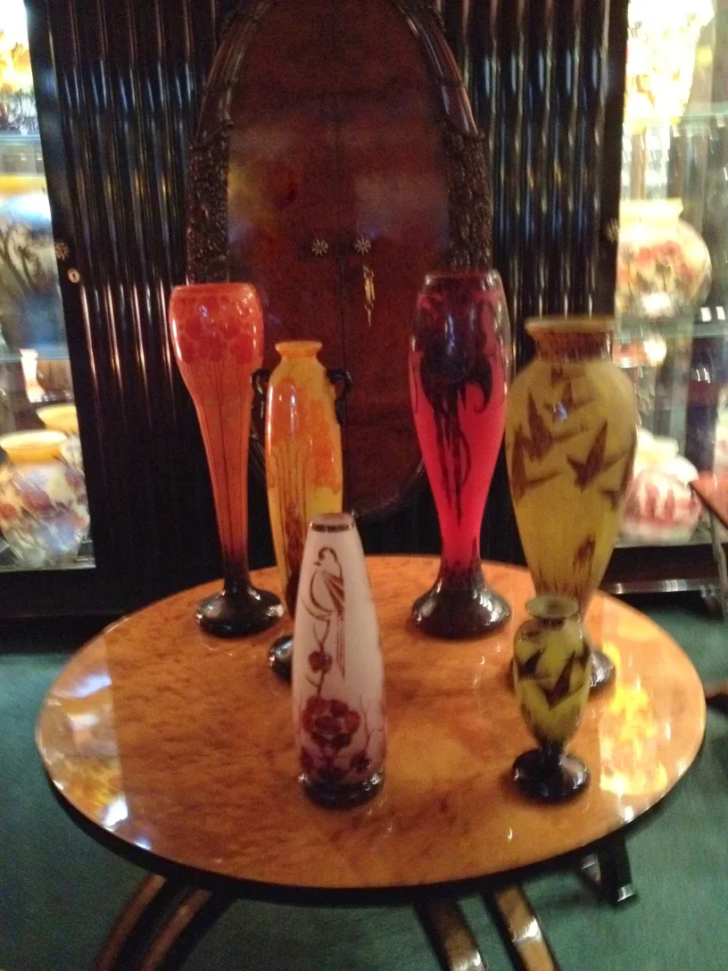 Six colorful glass vases on a table, antiques