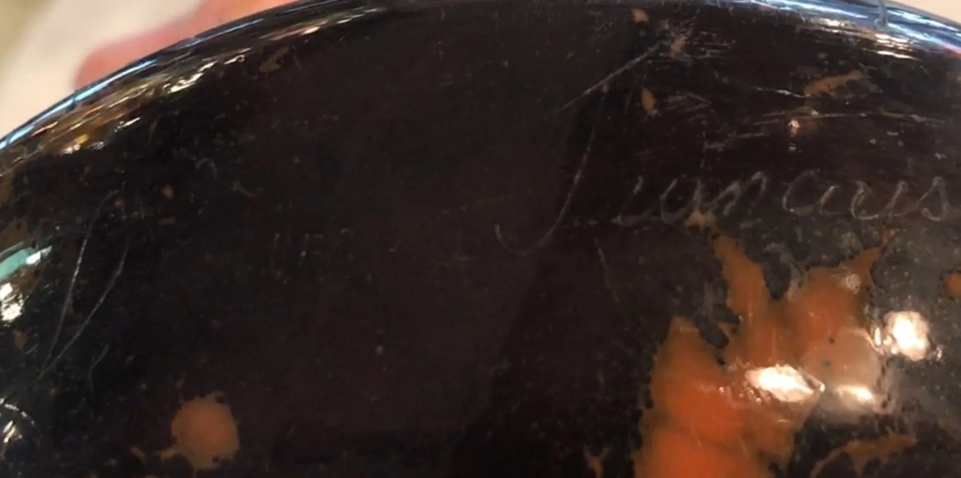 Antique signed glass Le Verre with visible details on the surface.