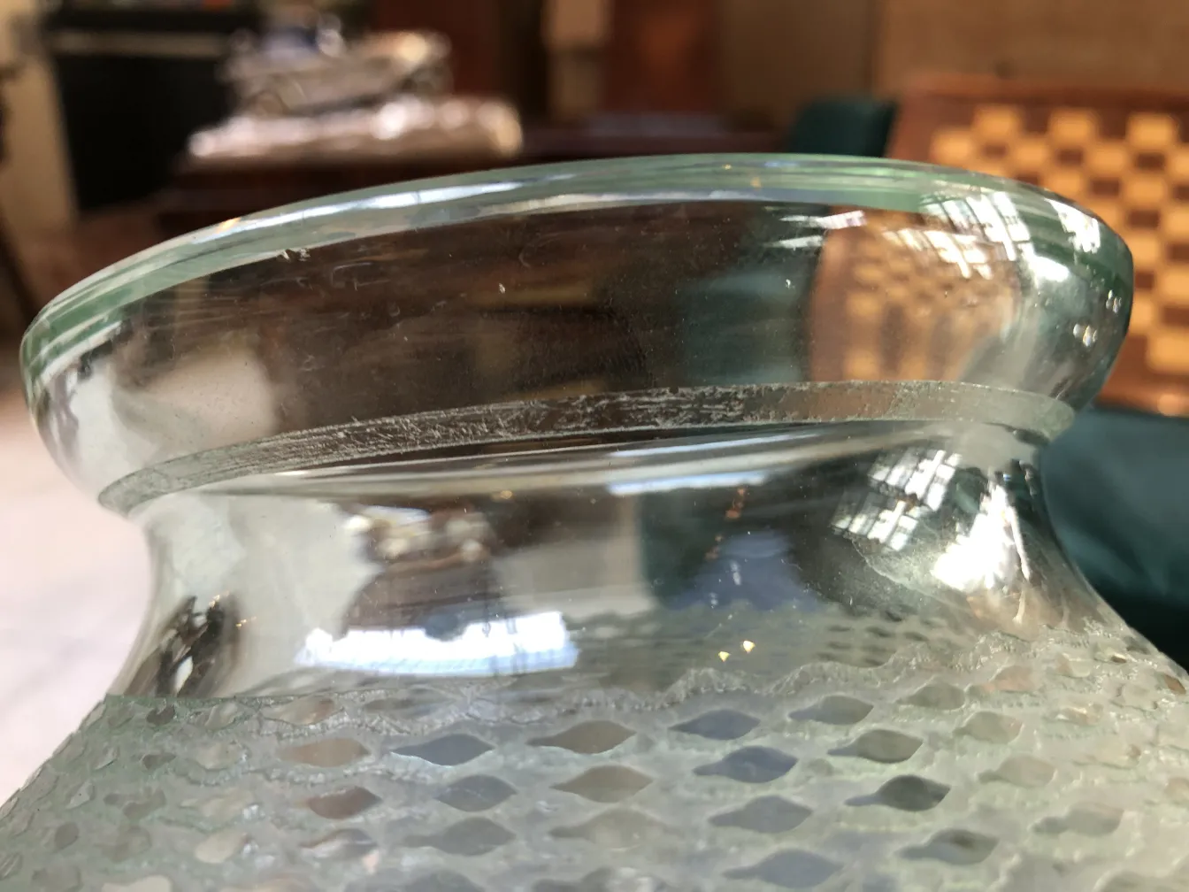 Details of the rim of the signed glass Daum Nancy in an antique setting.