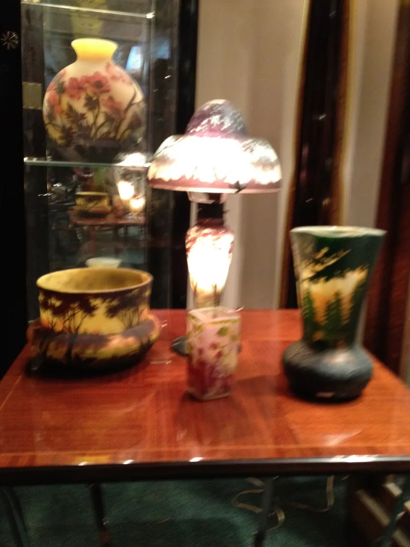 Signed glass Daum Nancy with floral design in an antique setting.