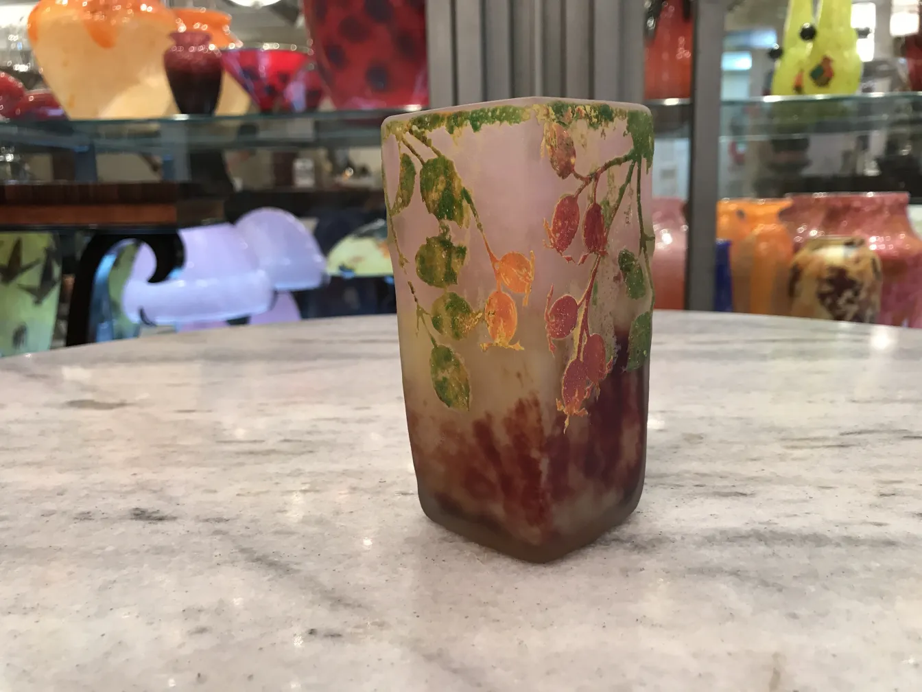 Side view of antique signed glass Daum Nancy with colorful leaf details.