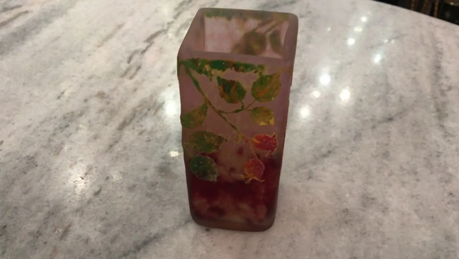 Signed glass Daum Nancy featuring decorative leaves in vibrant colors on a clear surface