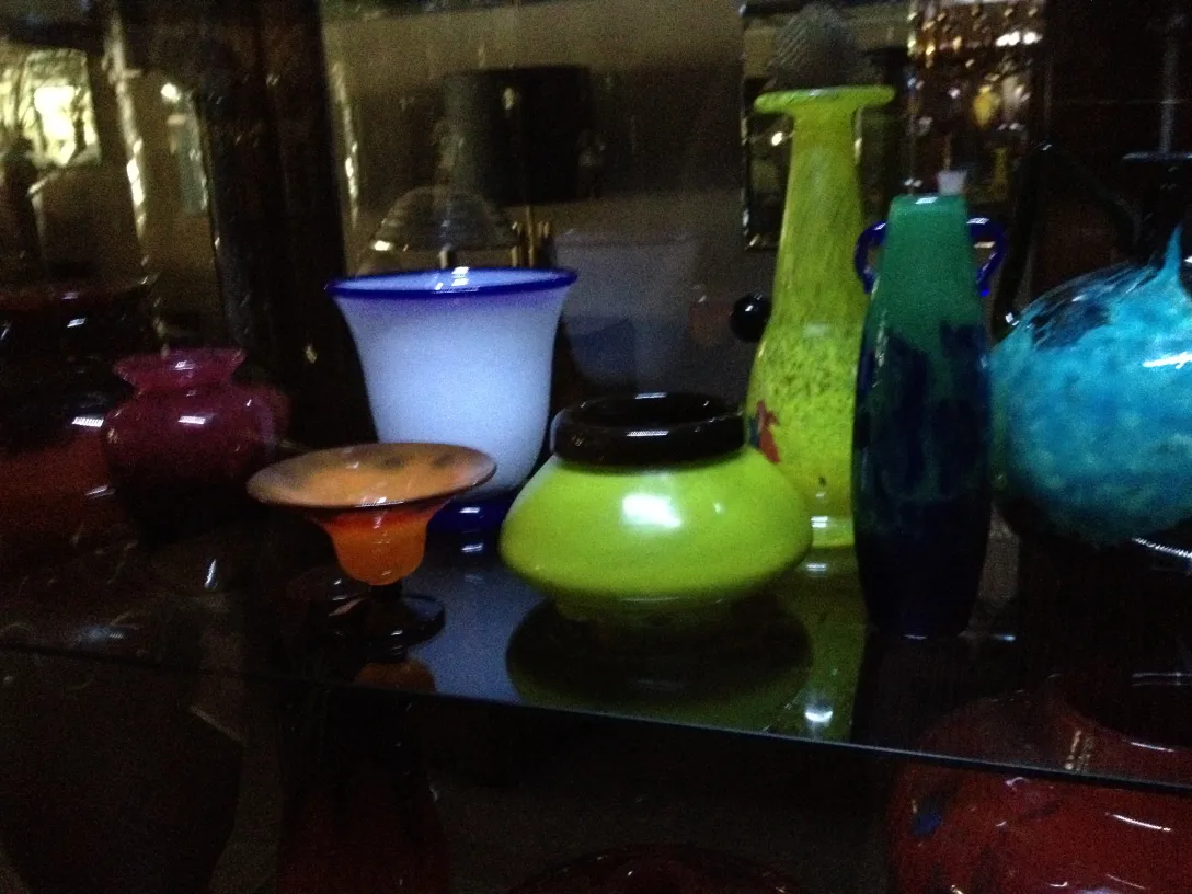 Signed glass Daum Nancy in various shapes and colors on a shelf