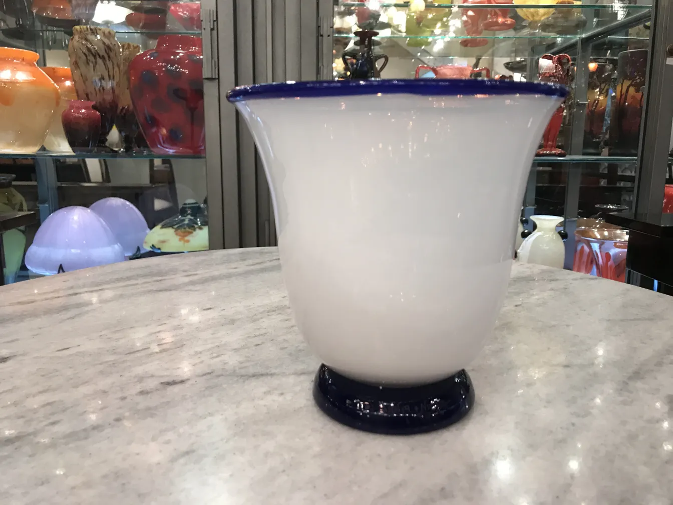 Signed glass Daum Nancy displayed in an antique setting.