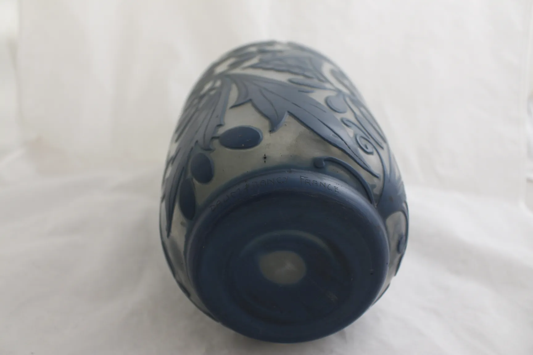 Antique signed glass Daum Nancy with dark blue floral design, light atmosphere.