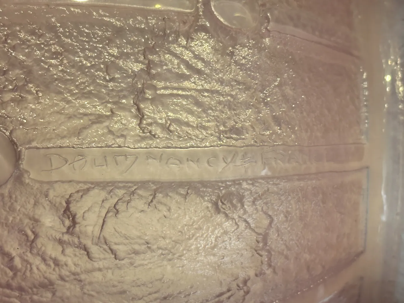 Signed glass Daum Nancy with textured and decorative details.