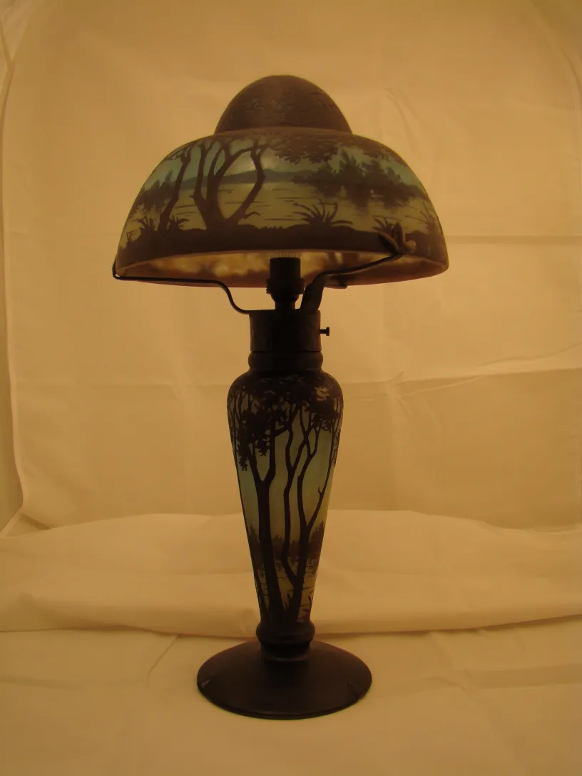 antique lamp featuring signed glass Daum Nancy, light background