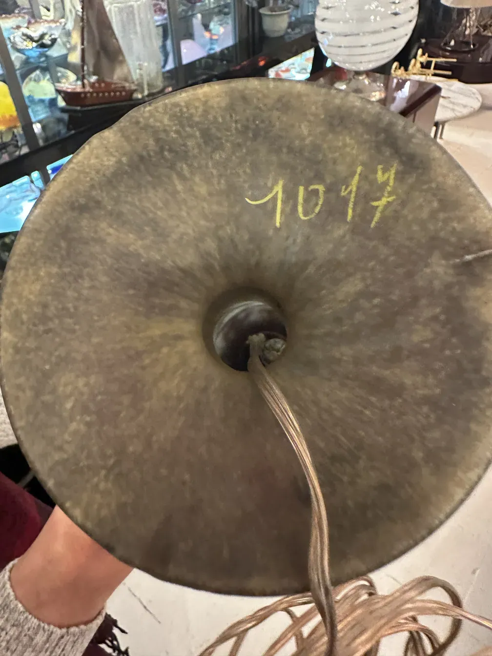 base of antique lamp with yellow signature, varied surroundings