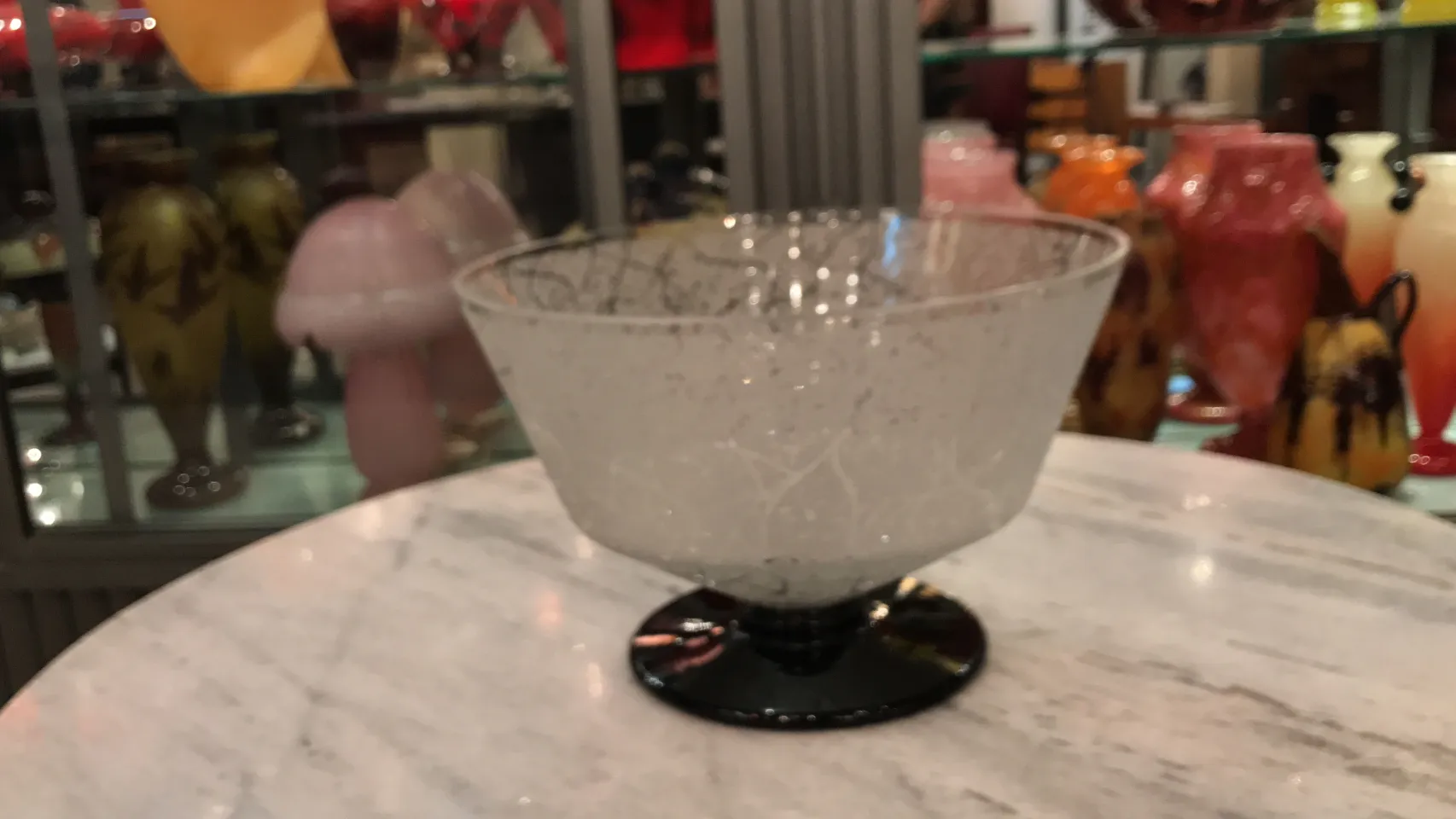 signed glass on a black base with subtle patterns, antique