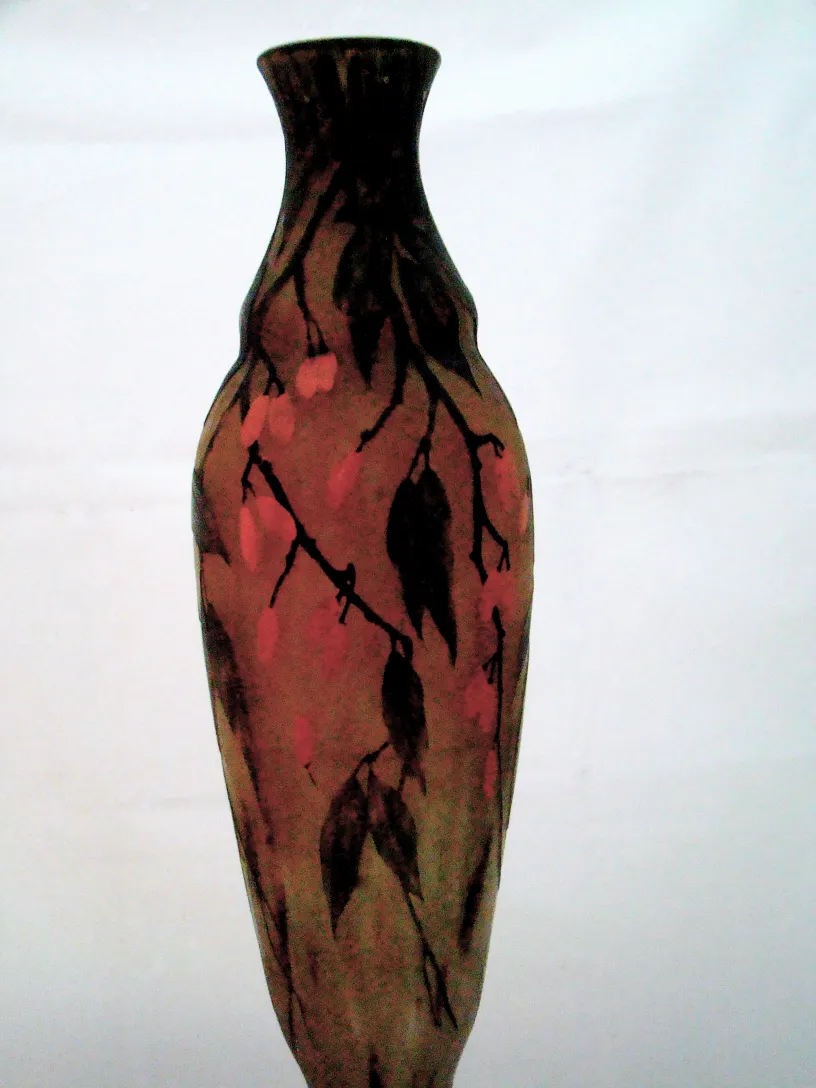 Botella antigua con diseño floral en tonos tierra y rosa.