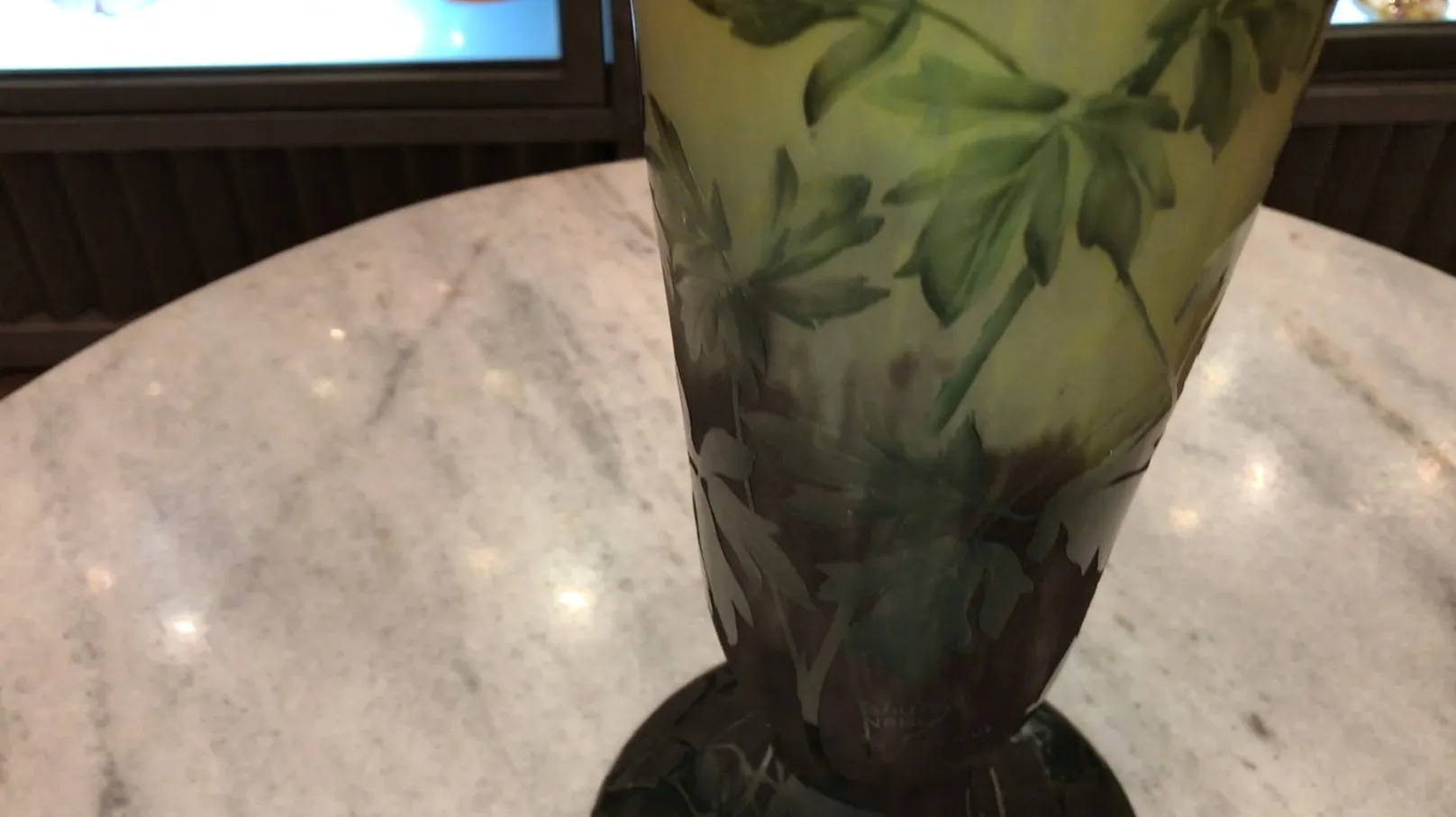 glass vase with green leaf design and signature