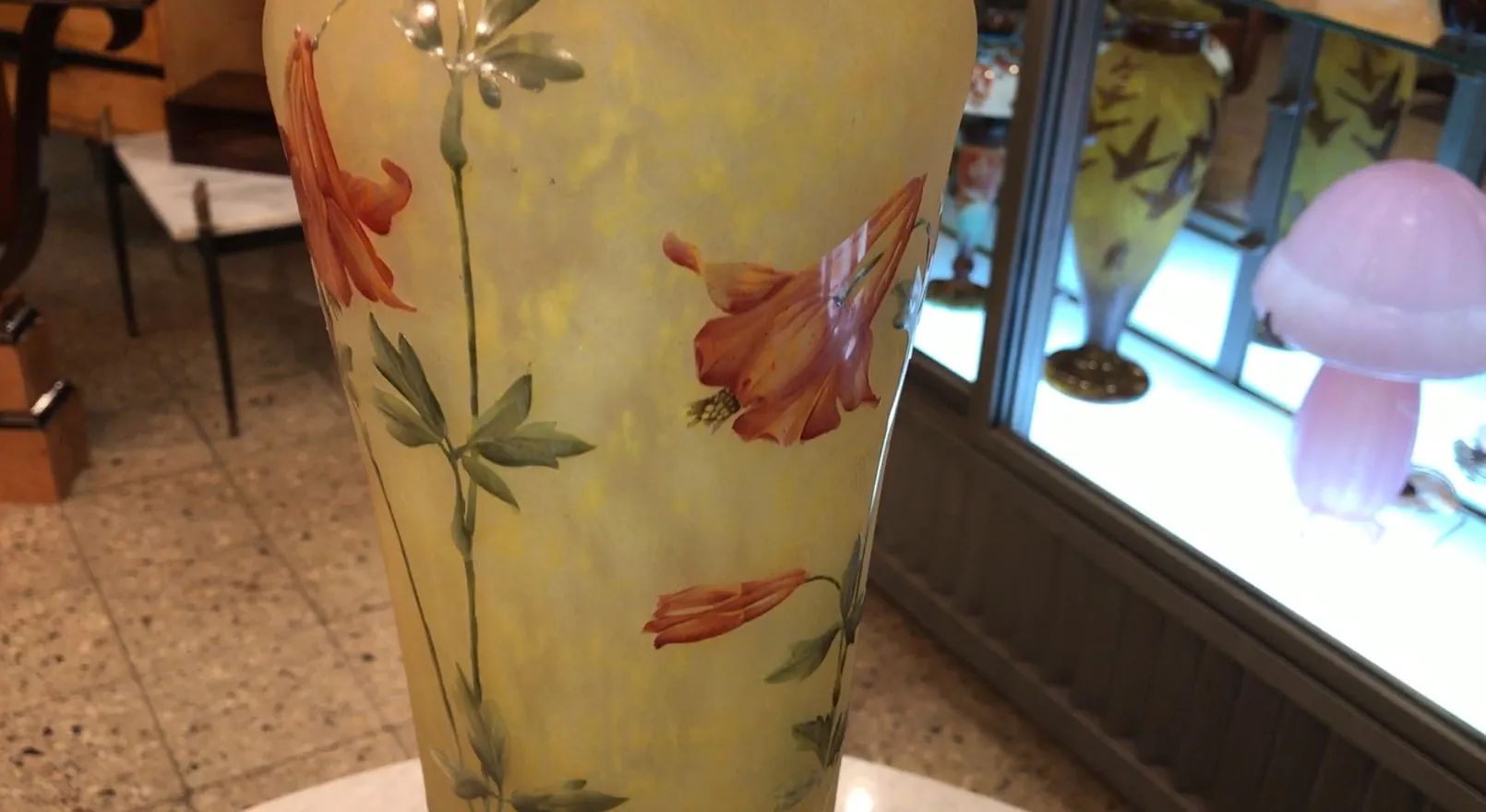 Elegante antike Vase mit floralem Design in Gelb- und Orangetönen.