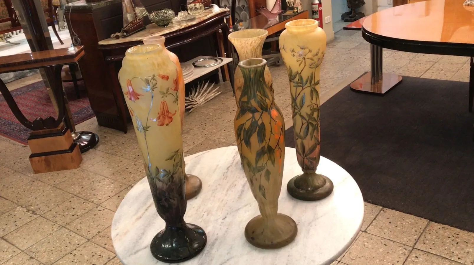 Beautiful signed glass Daum Nancy with floral design, antiques in elegant setting.